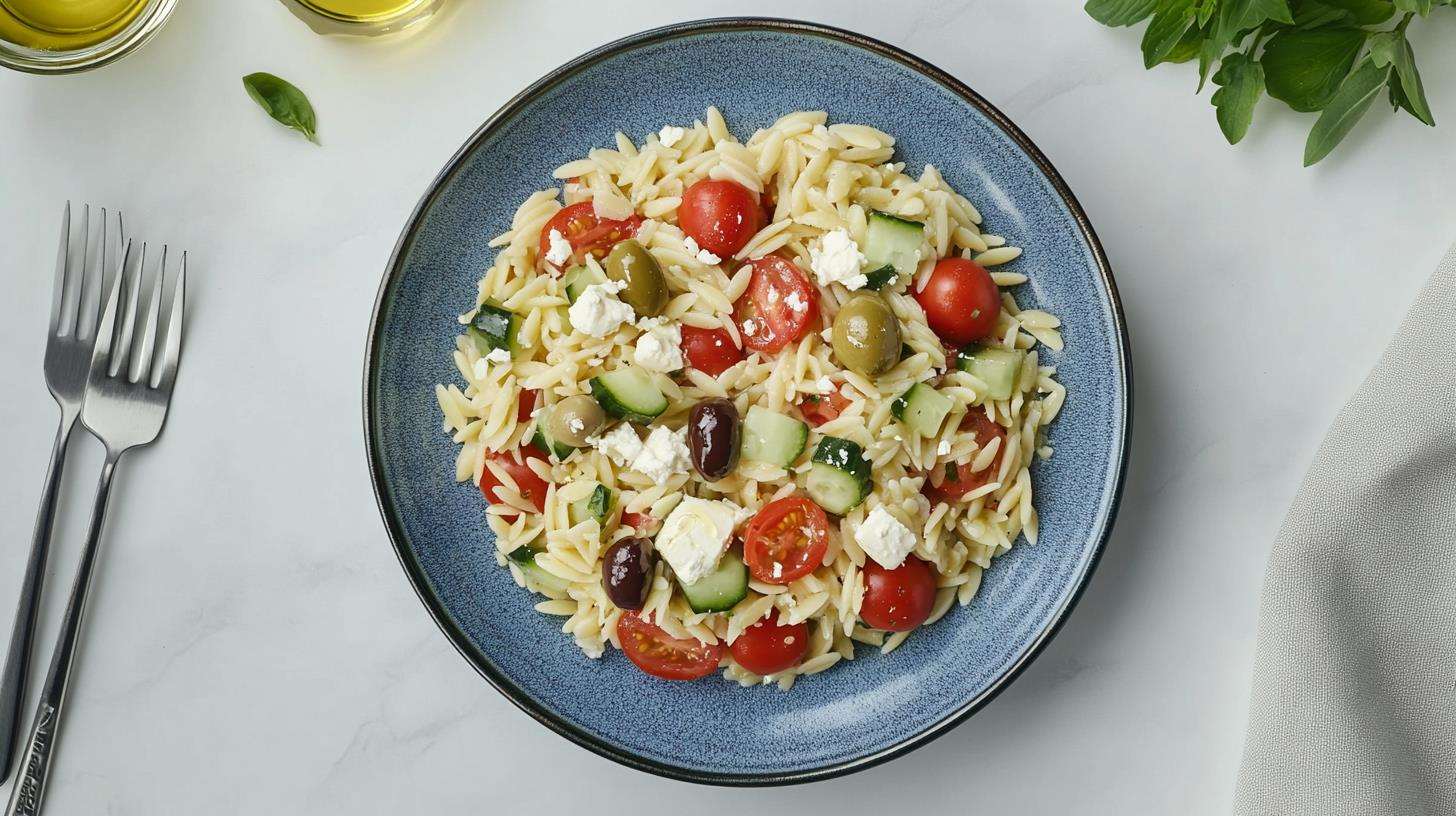 Mediterranean orzo salad with fresh vegetables and feta cheese.